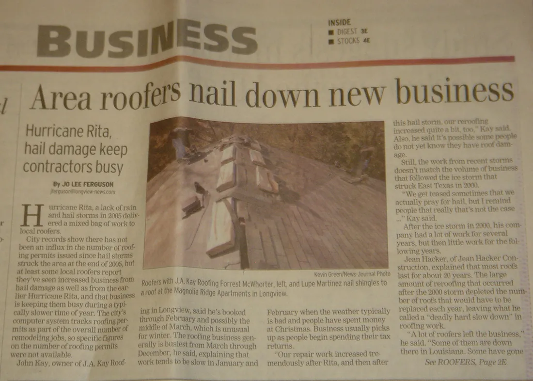A Longview News-Journal business page headlined Area roofers nail down new business, with a photo of two J. A. Kay Roofing roofers nailing shingles on an apartment roof